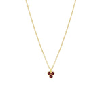Gold necklace with a small triangle red garnet pendant on a white background