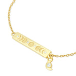 Gold bar bracelet with moon phase charms on a white background