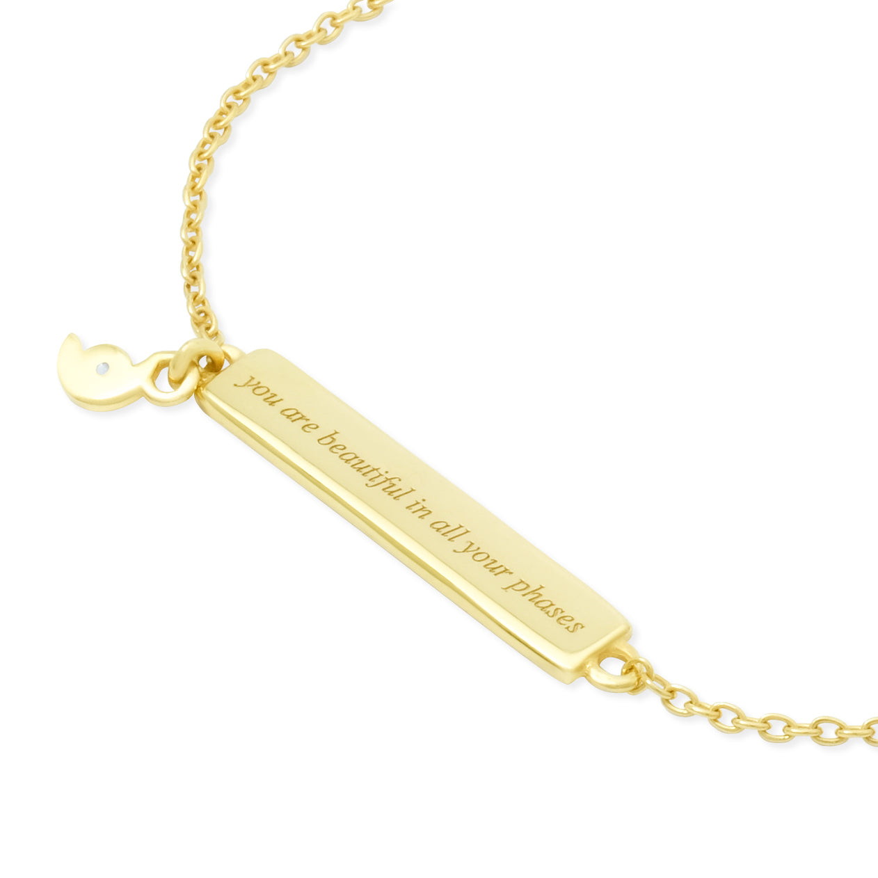 Gold bracelet with a bar pendant and quote engraving on a white background