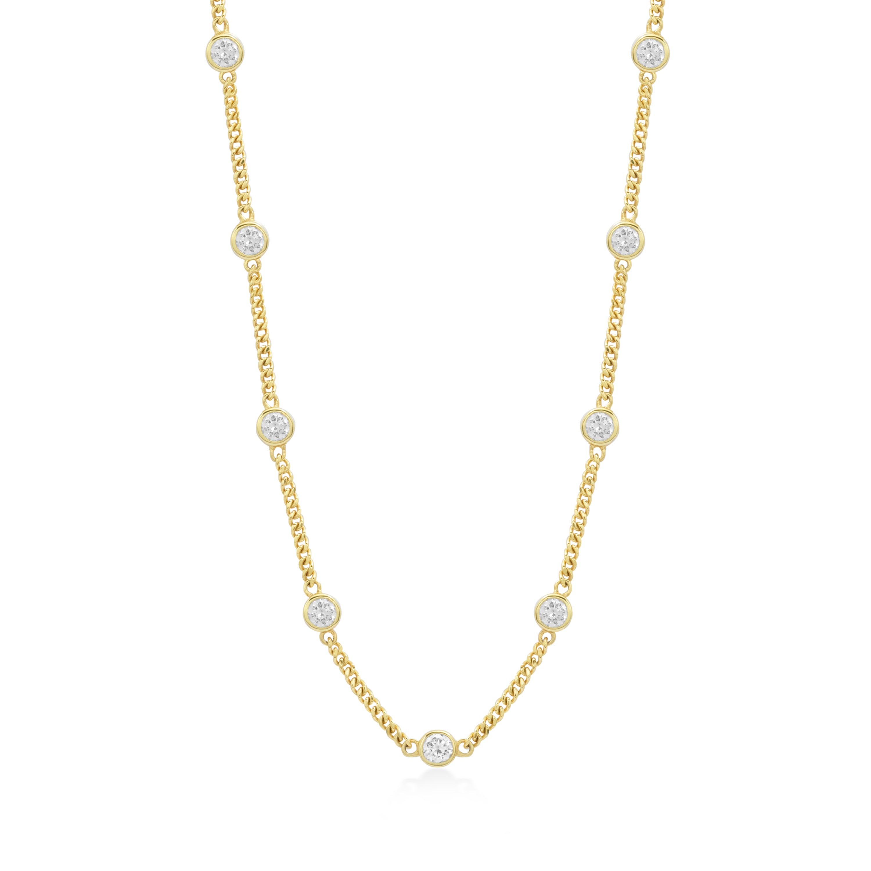 Gold necklace with bezel set clear stones on a white background