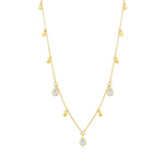 Gold necklace with teardrop-shaped clear stone pendants on a white background
