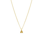 Gold necklace with a small yellow citrine triangle pendant on a white background