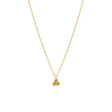 Gold necklace with a small yellow citrine triangle pendant on a white background