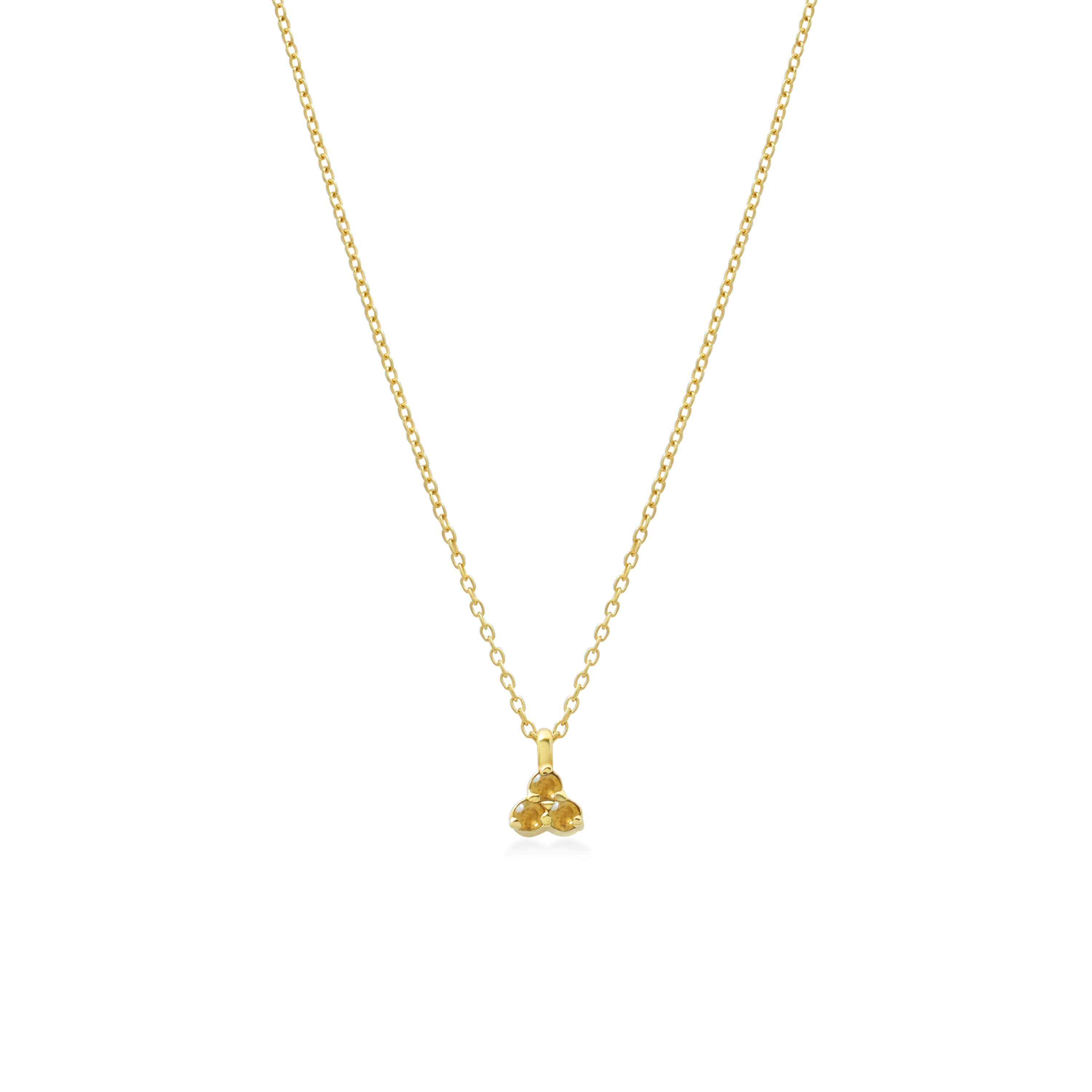 Gold necklace with a small yellow citrine triangle pendant on a white background