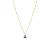 Gold necklace with a small blue purple gemstone triangle pendant on a white background