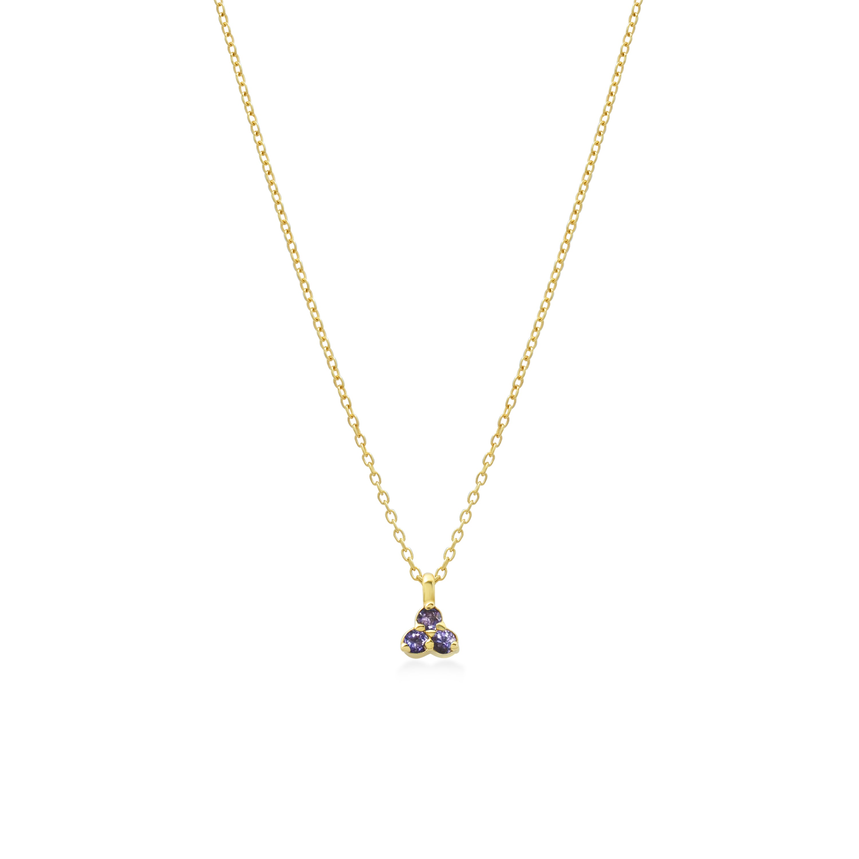 Gold necklace with a small blue purple gemstone triangle pendant on a white background