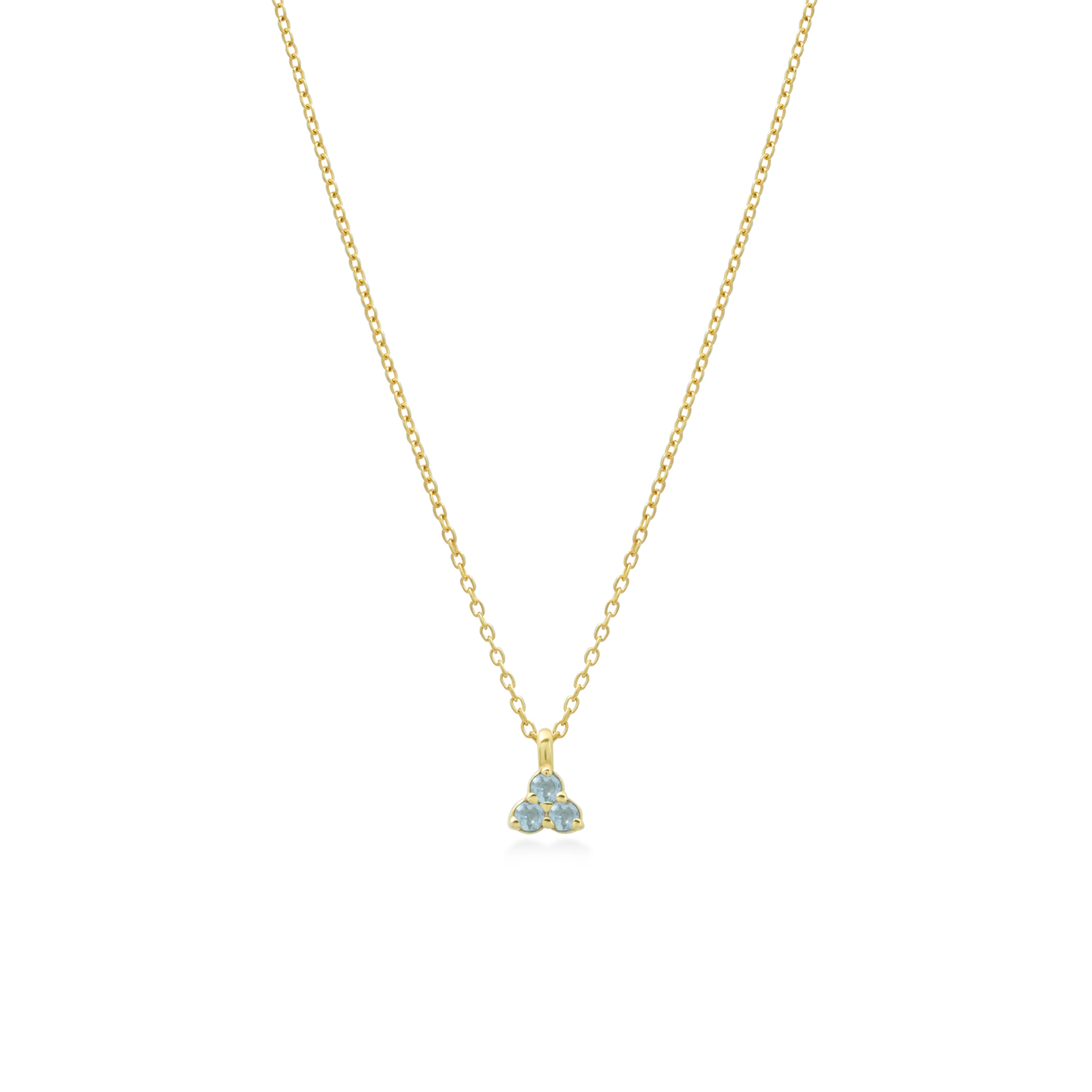 Gold necklace with a small triangular aquamarine pendant on a white background