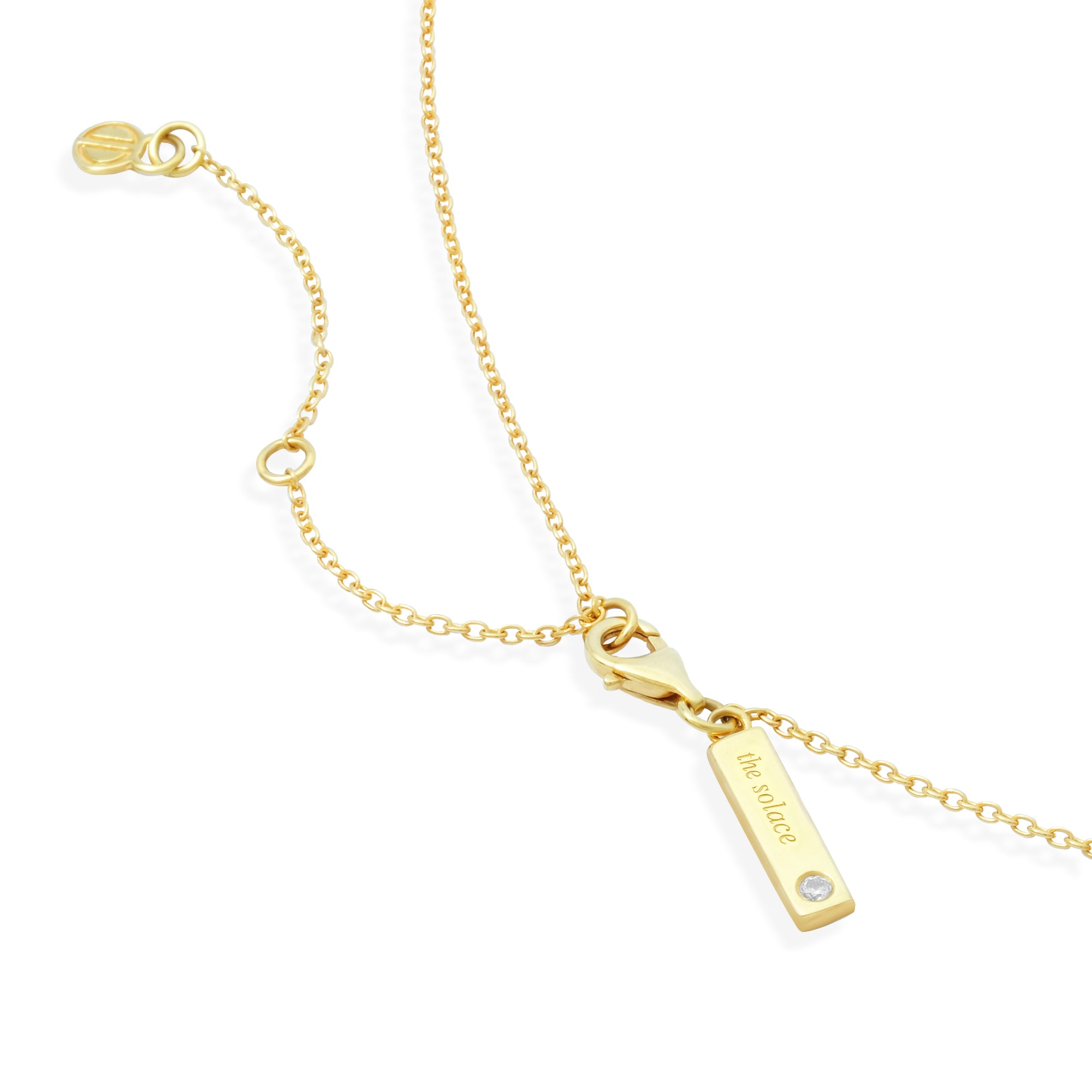 Gold necklace with a bar pendant on a white background