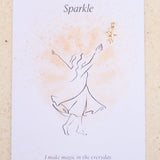 Feminine illustration and star charm with the word 'Sparkle' on a beige background