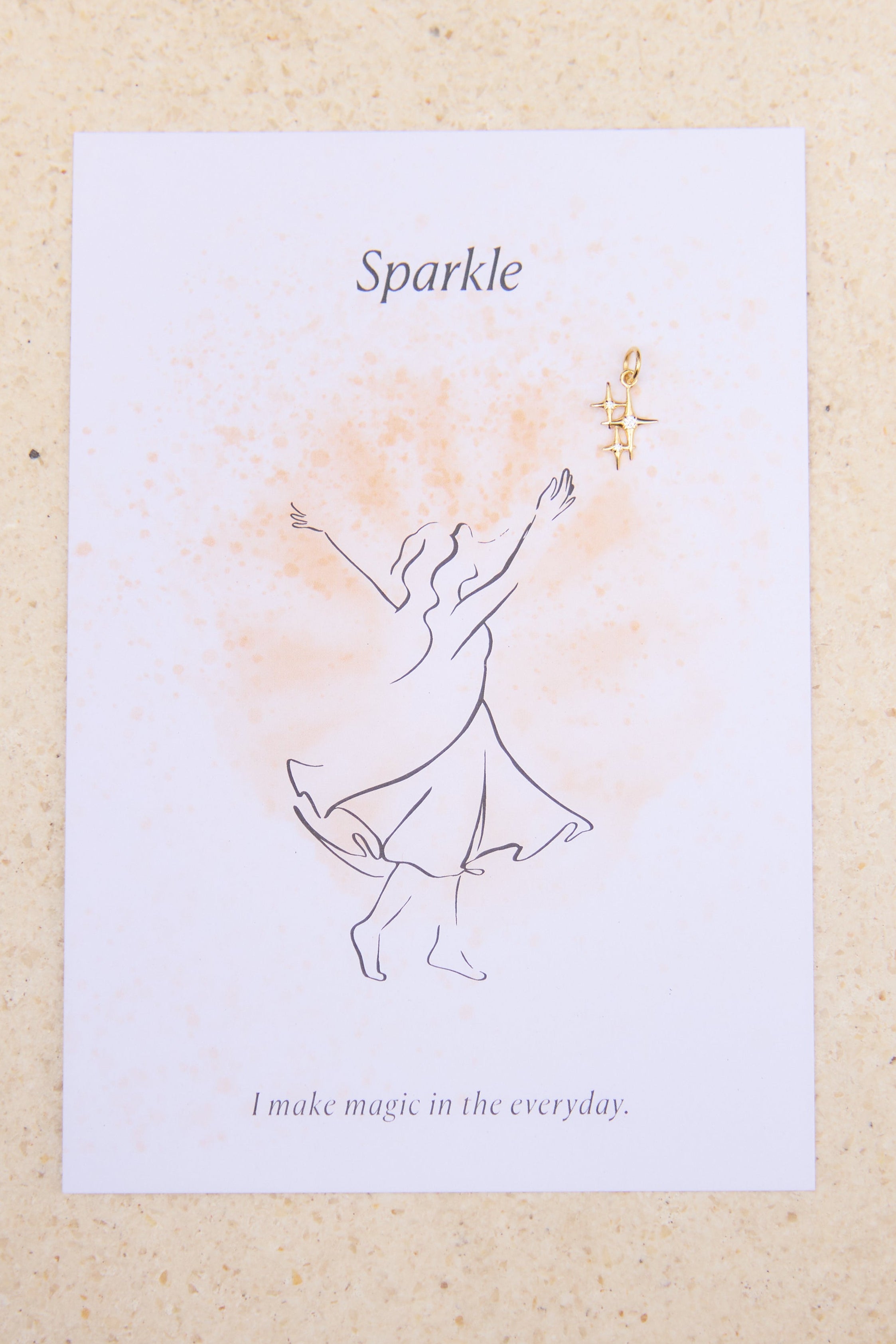 Feminine illustration and star charm with the word 'Sparkle' on a beige background