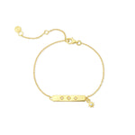 Gold bracelet with stars and clear stones on a white background