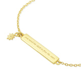 Gold bracelet with a engraved bar pendant and star charm on a white background